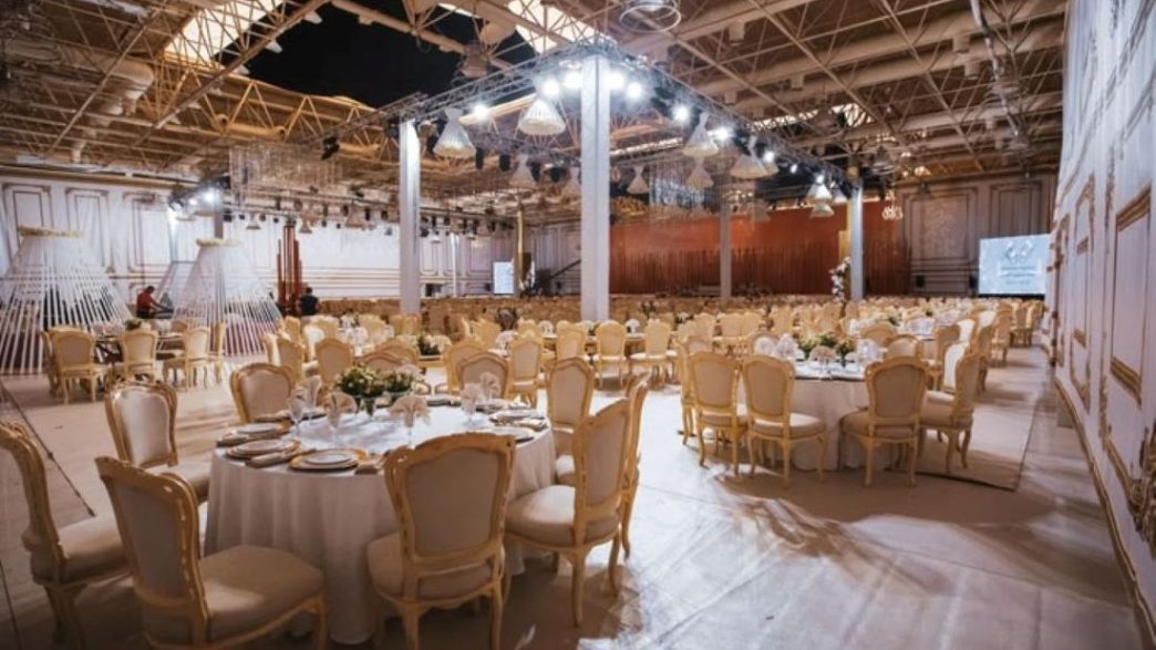 Elegant indoor event hall with banquet seating and decorative lighting