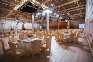 Elegant indoor event hall with banquet seating and decorative lighting