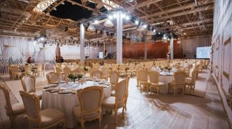Elegant indoor event hall with banquet seating and decorative lighting