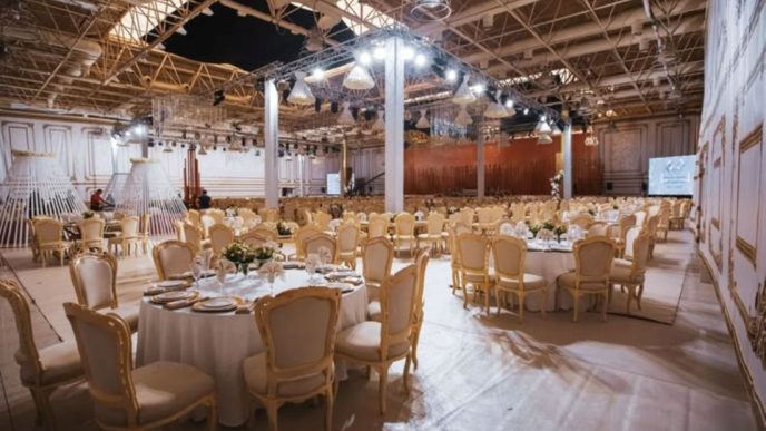 Elegant indoor event hall with banquet seating and decorative lighting