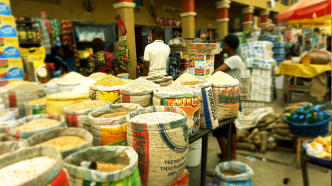 Traders selling garri, maize and beans at a Lagos market, one of the food items that have become cheaper in Nigeria