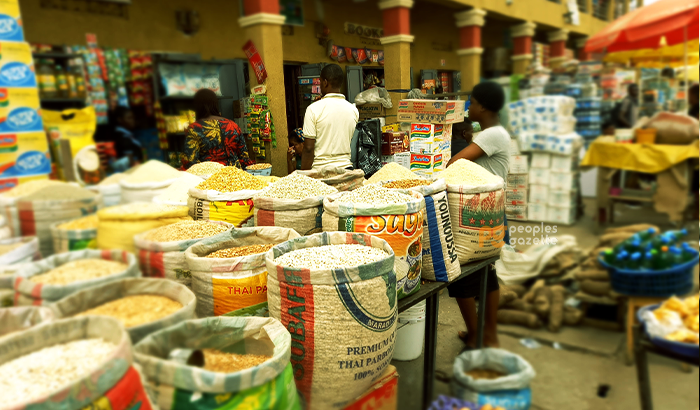 Traders selling garri, maize and beans at a Lagos market, one of the food items that have become cheaper in Nigeria