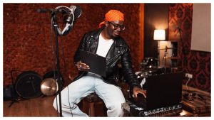 Nigerian musician creating music in a studio