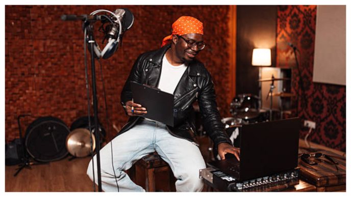 Nigerian musician creating music in a studio