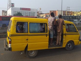 Nigerian commuters in a commercial yellow bus