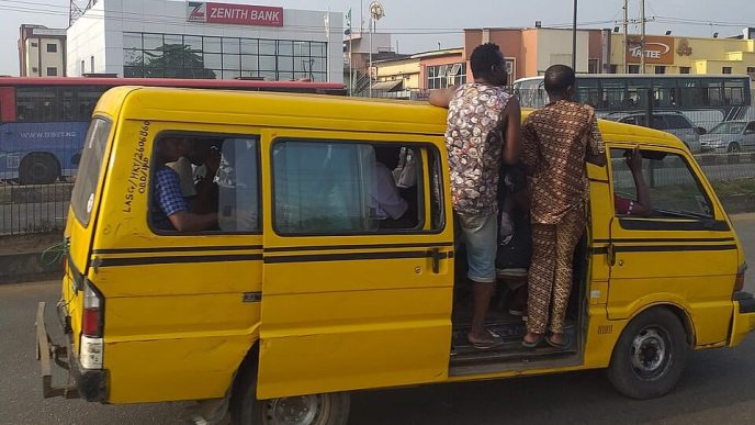 Nigerian commuters in a commercial yellow bus