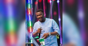 Toluwanisings performing on stage during a gospel music event