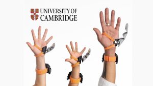 Human augmentation: Three hands demonstrate the wearable robotic Third Thumb developed to extend hand function.