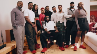 Burna Boy with family and collaborators in the No Giant Stands Alone campaign